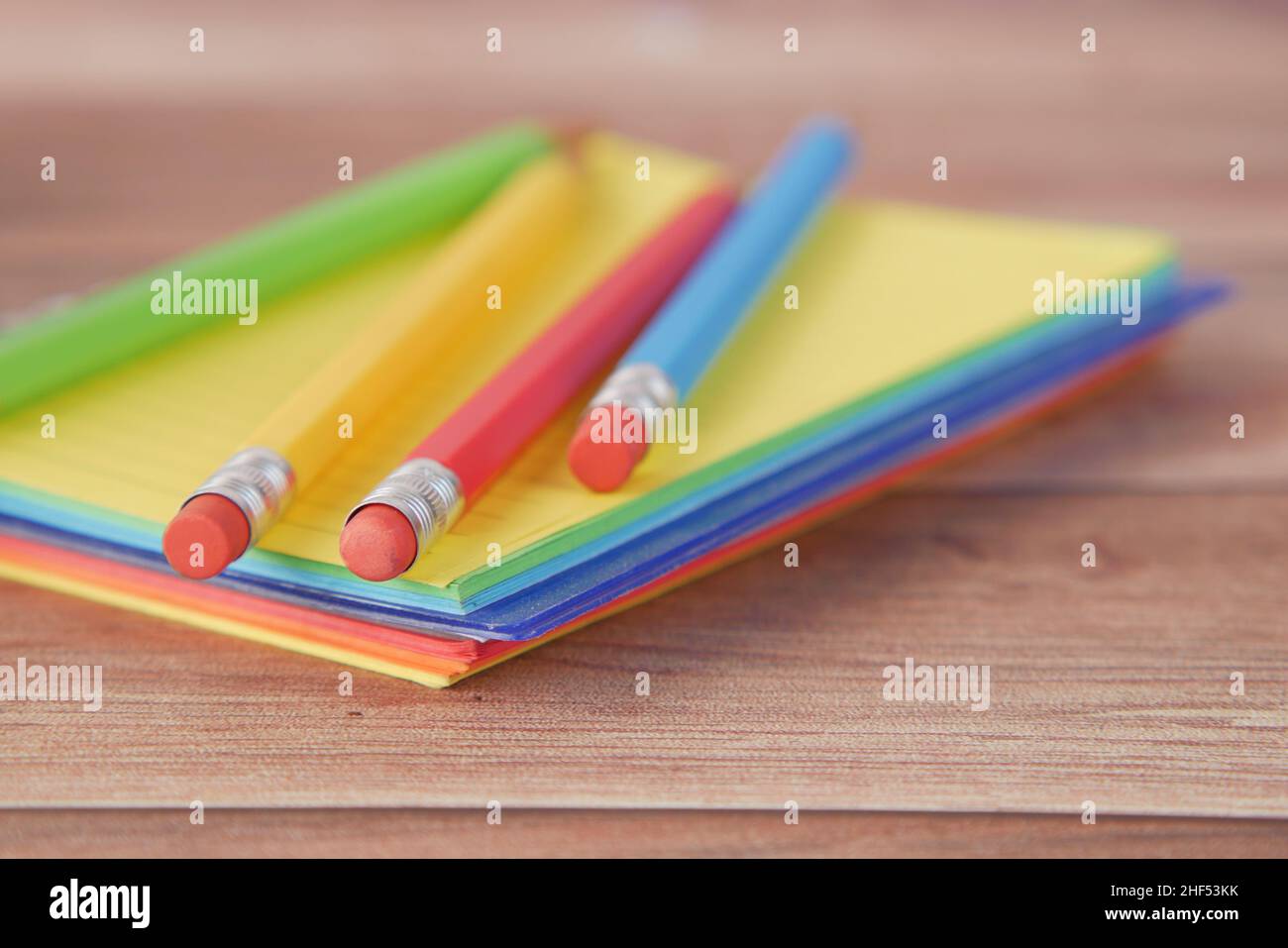 Close up of colorful pencils on notepad Stock Photo - Alamy