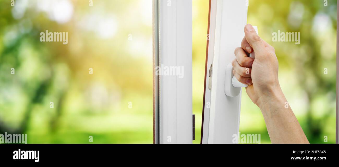 hand open plastic pvc window. banner copy space Stock Photo