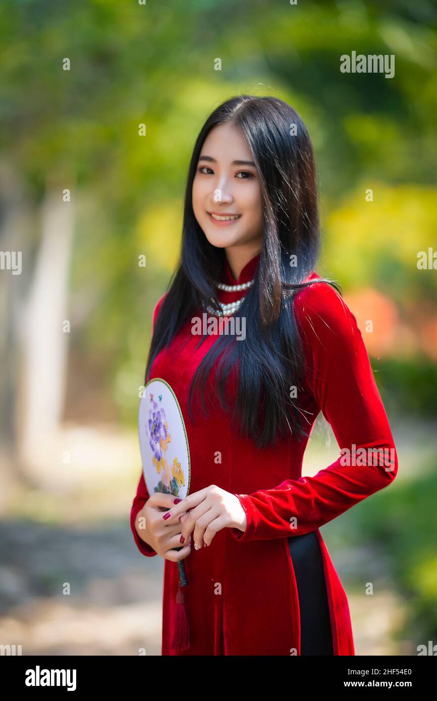 Ho Chi Minh City, Vietnam - March 1, 2021: Portrait of a beautiful girl in a red ao dai Stock Photo