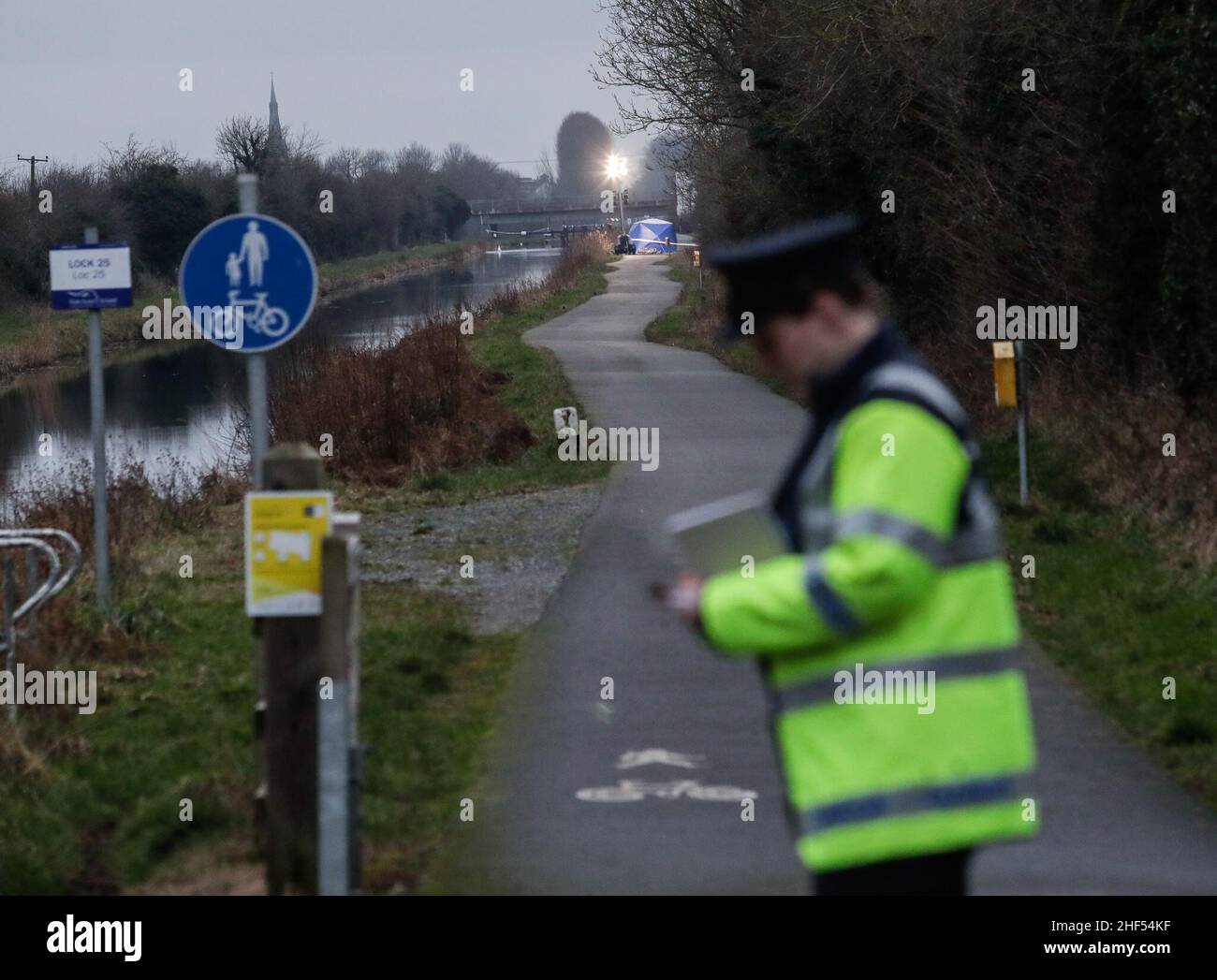 A Garda takes notes beside the Grand Canal in Tullamore, County Offaly