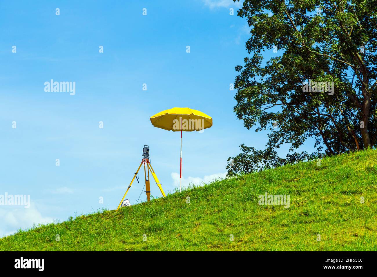 surveying the area by geodesy under blue sky Stock Photo