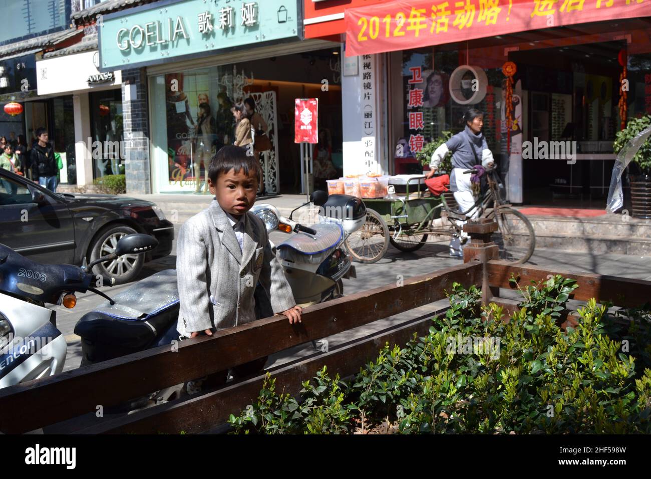 chinese boy curiously watch the camera in yuann, lijiang tourist area Stock Photo