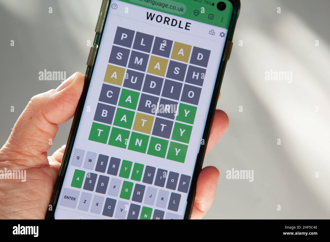 Londn, UK, 14 January 2022: A game of Wordle being played on a mobile phone. The game has gained over two millions players since being created by Josh Wardle, a Welsh-born Brooklyn-based software engineer. With one single game released per day, fans are sharing their results on social media which is driving it's popularity. Anna Watson/Alamy Live News Stock Photo