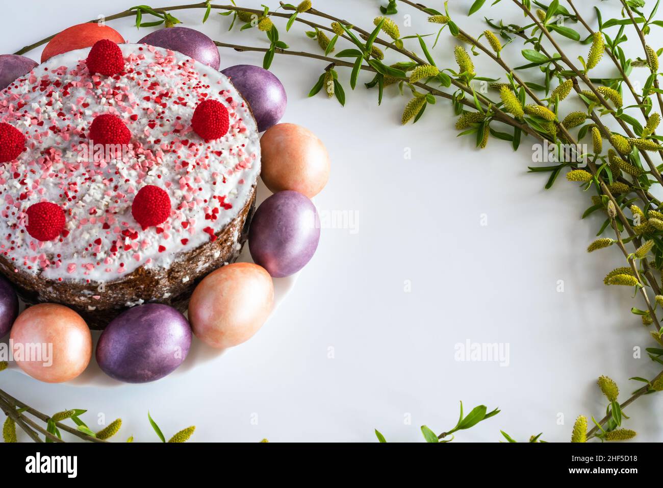 Easter cake and painted Easter eggs with willow branches. Horizontal photo. Stock Photo