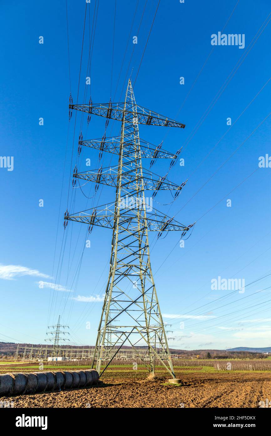 High voltage pylons tower under blue sky Stock Photo - Alamy
