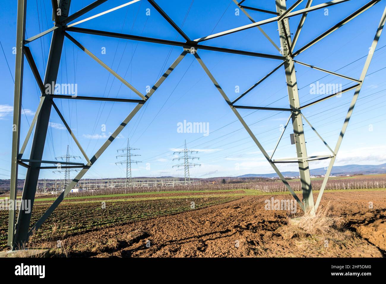 High voltage pylons tower under blue sky Stock Photo - Alamy