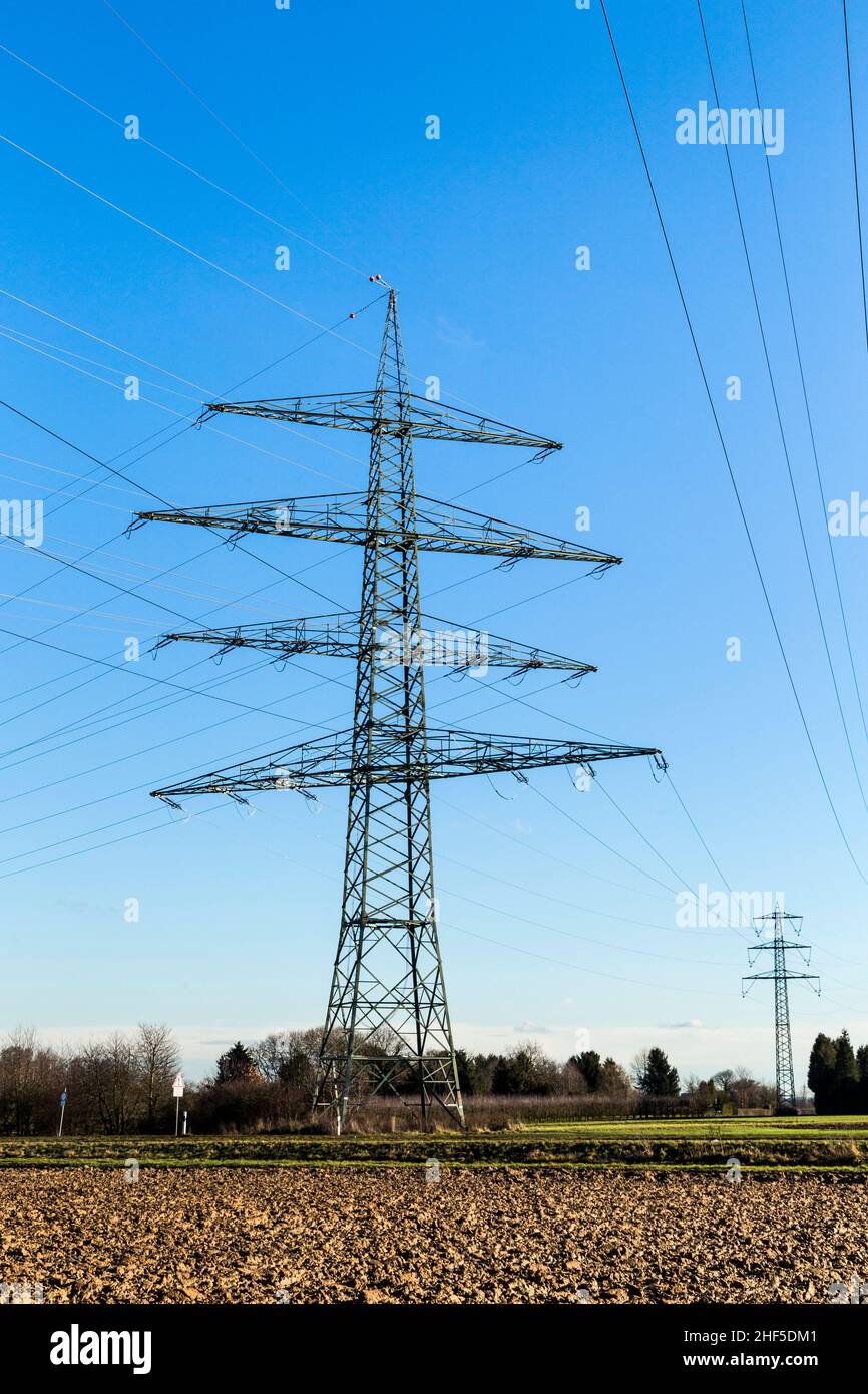 High voltage pylons tower under blue sky Stock Photo - Alamy