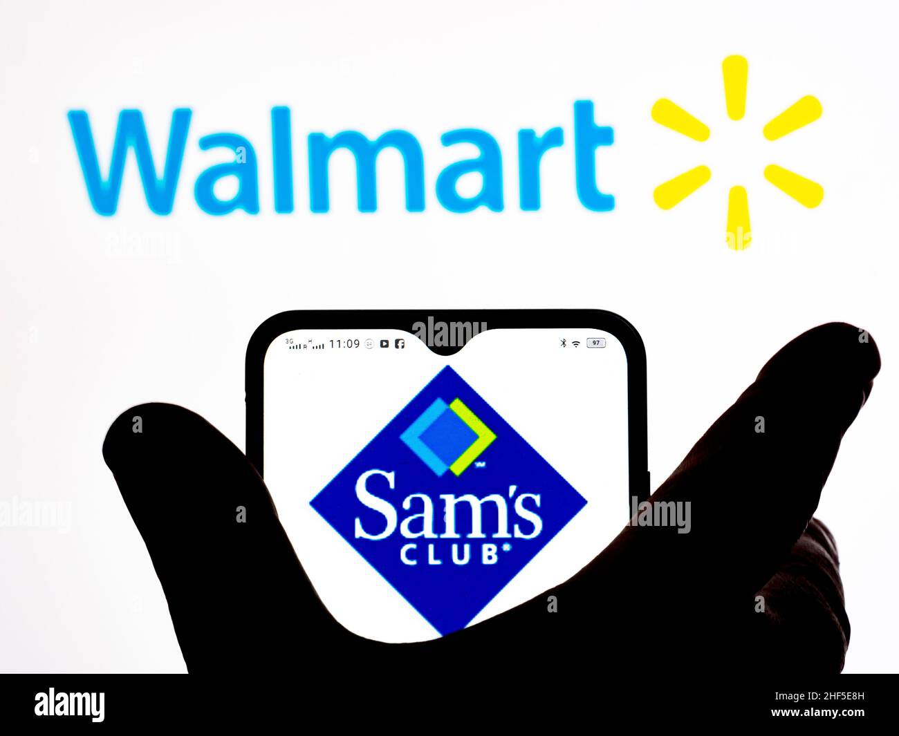 In this photo illustration, the Sam's Club brand by Walmart logo is seen displayed on a smartphone screen with the Walmart logo in the background. Stock Photo