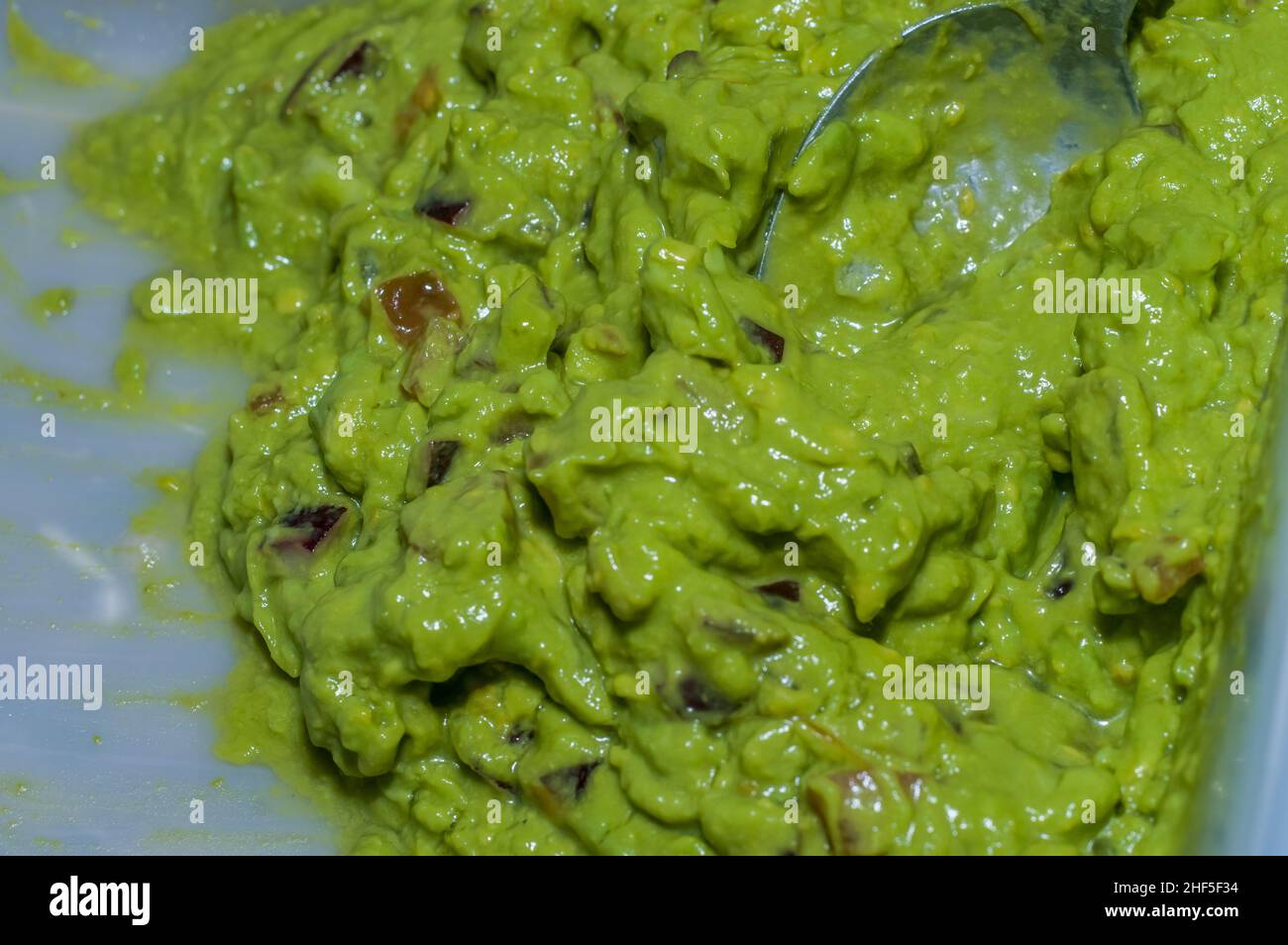 guacamole texture with spoon and copy space, Stock Photo