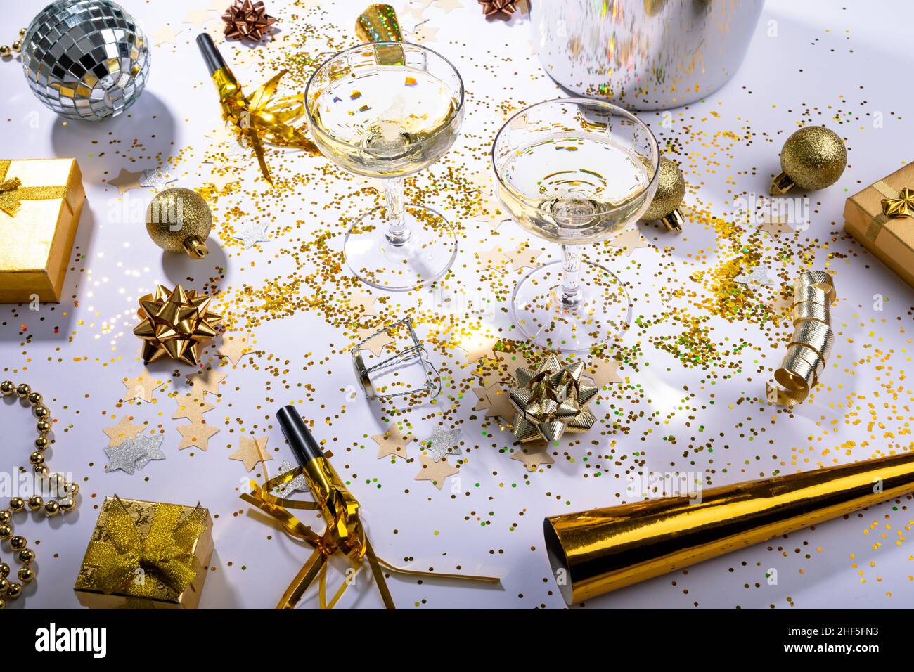 Champagne glasses with gold and silver colored decoration on table, copy space Stock Photo
