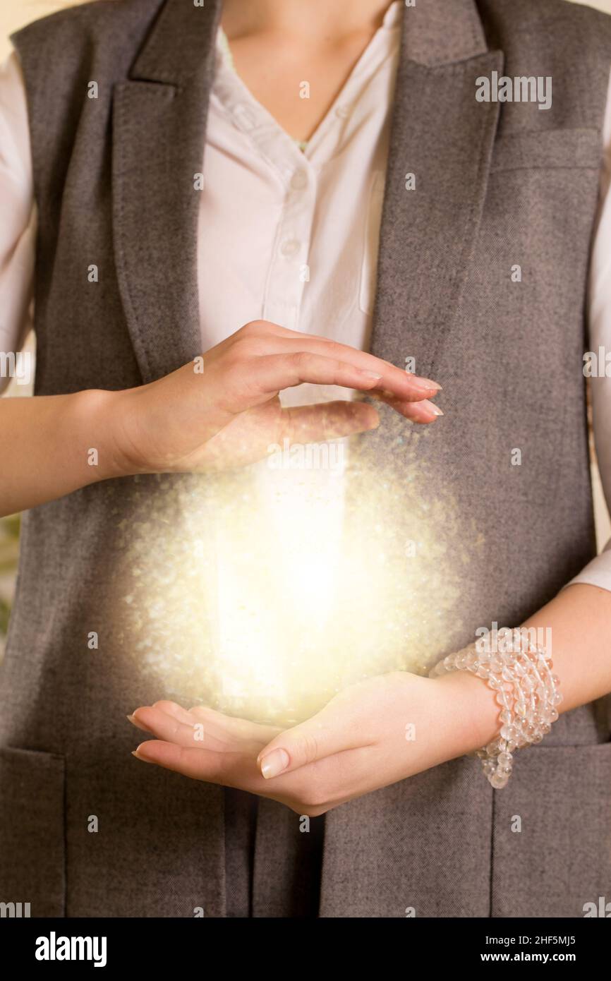 Young woman holding reiki energy in her hands Stock Photo