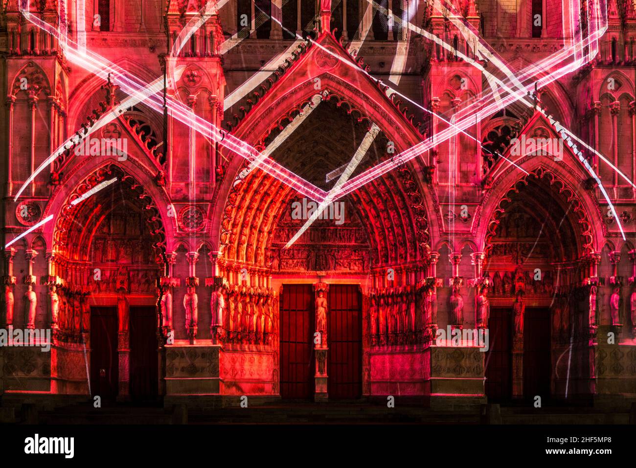 FRANCE. SOMME (80). AMIENS. THE NOTRE-DAME CATHEDRAL. NIGHT SHOW 'CHROMA' (SOCIETY SPECTER LAB) PROJECTED ON THE WESTERN FACADE. (HERE: ON THE 3 PORTA Stock Photo