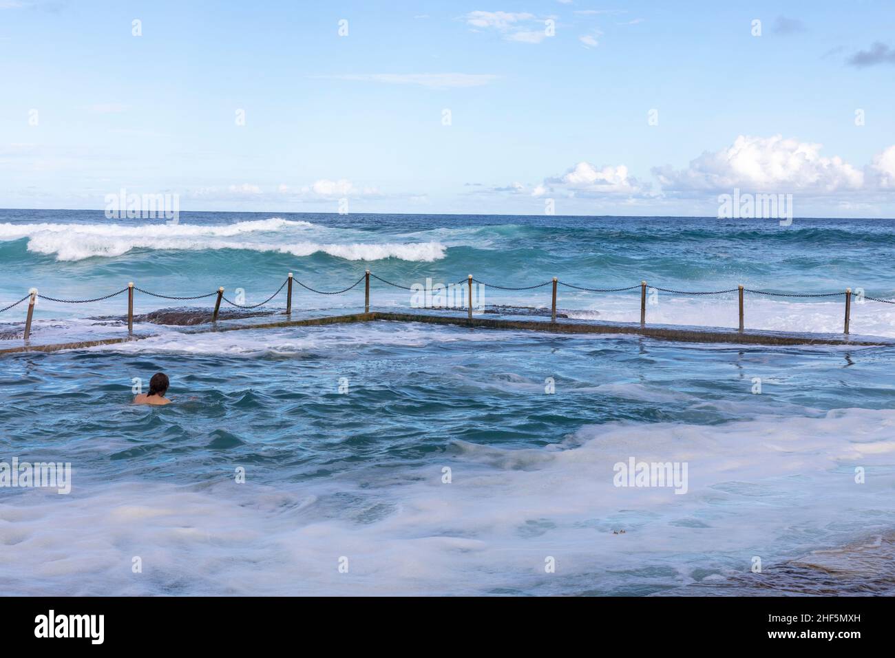 Avalon Beach ocean pool with person swimming in the open water rock pool, Avalon Beach Sydney,Australia blue sky summer Stock Photo