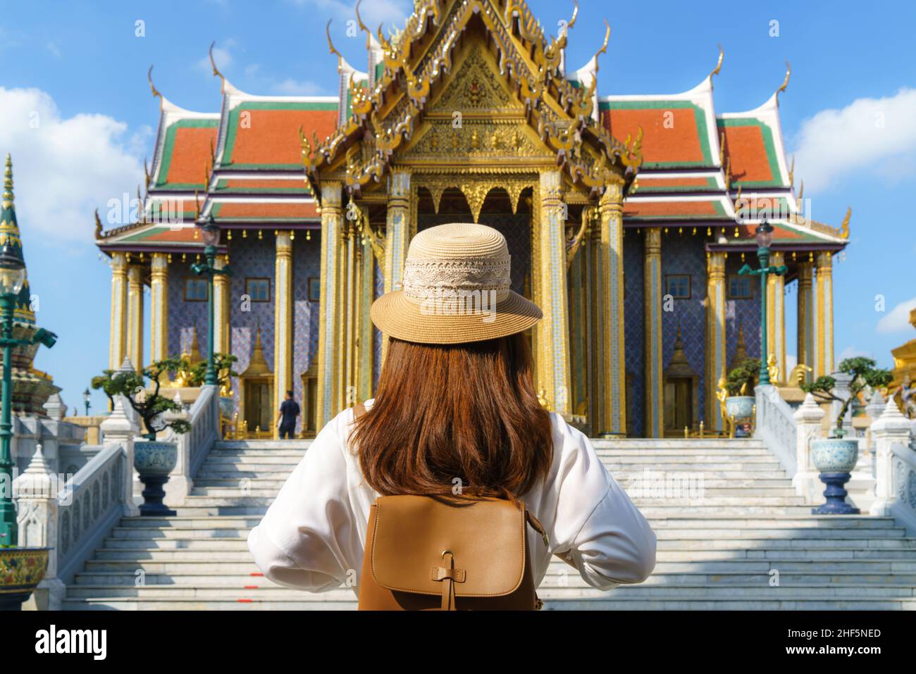 Asian woman traveler at Wat phra keaw is Buddhist temple in Bangkok, Thailand. It is one of Bangkok's most beautiful temples Stock Photo