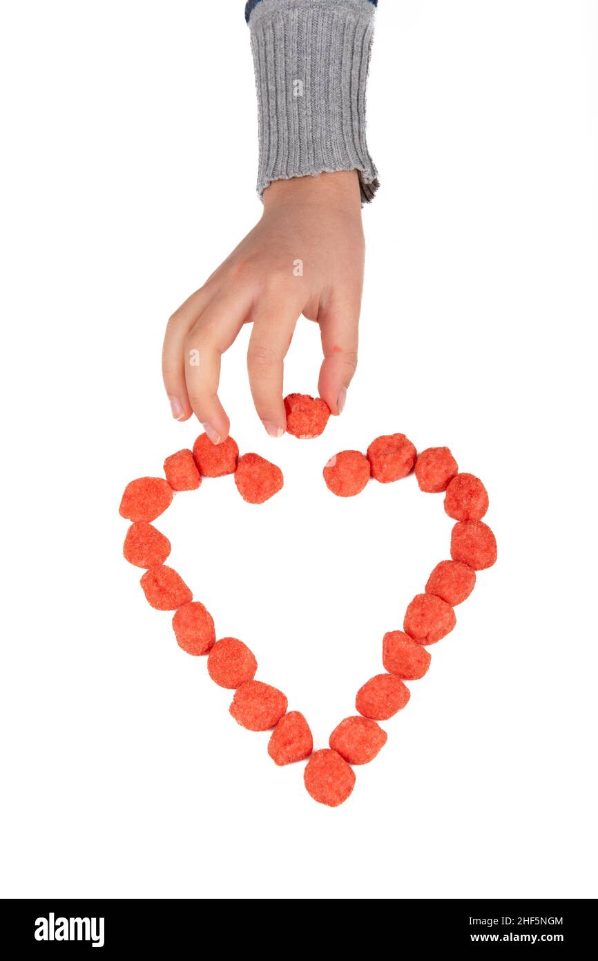 Heart made with candy on white background Stock Photo