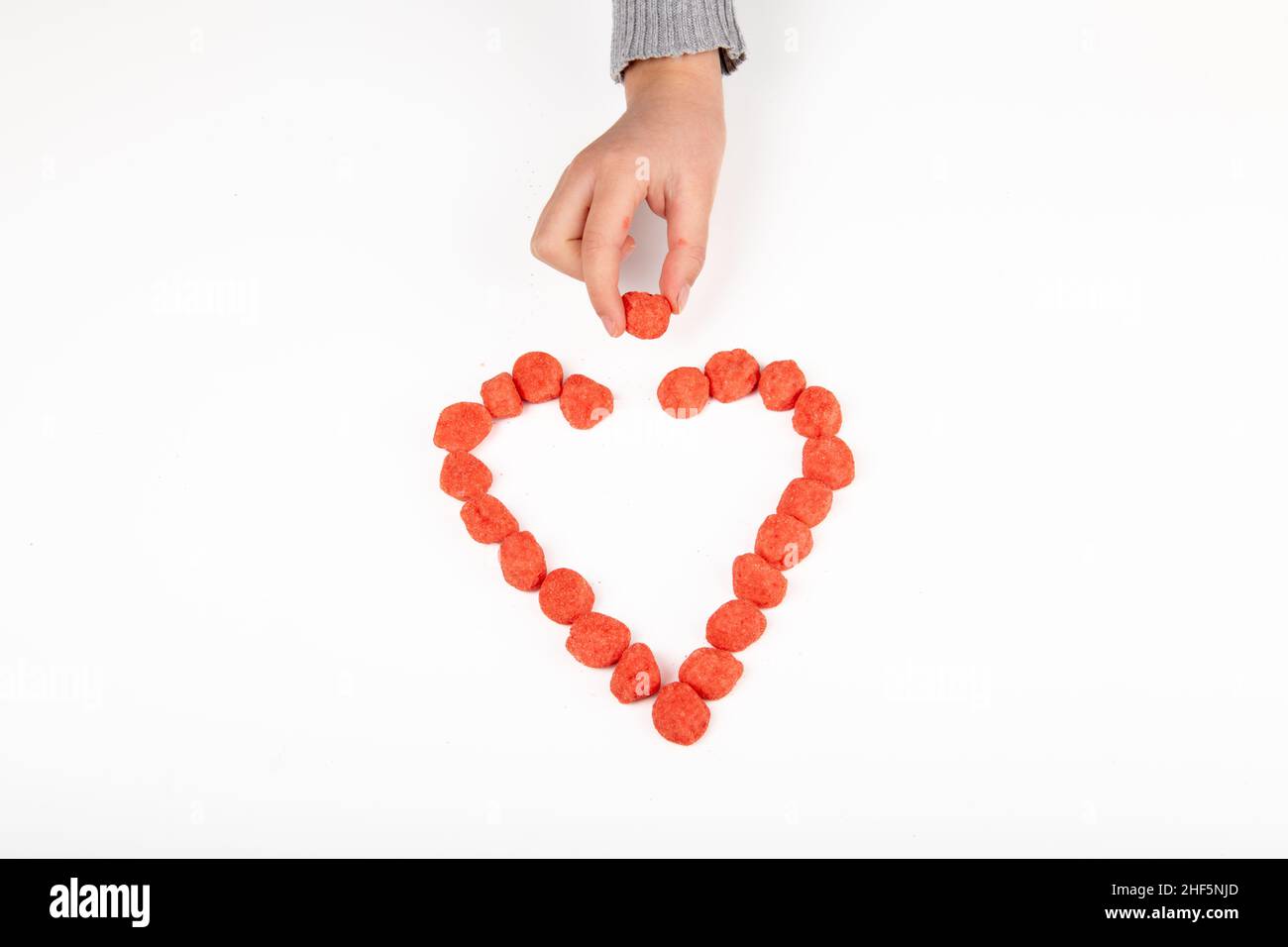 Heart made with candy on white background Stock Photo