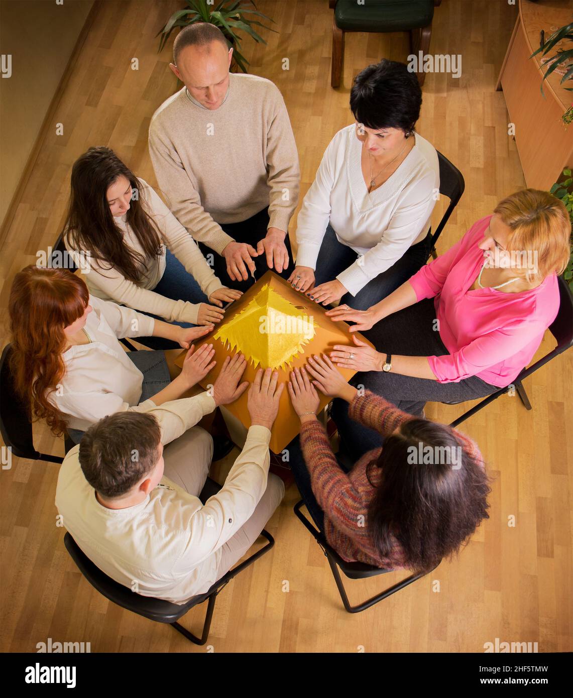 Group meditation aims to heal the whole world from coronavirus. Group charge of the energy of the pyramid of desires in the stream of reiki Stock Photo