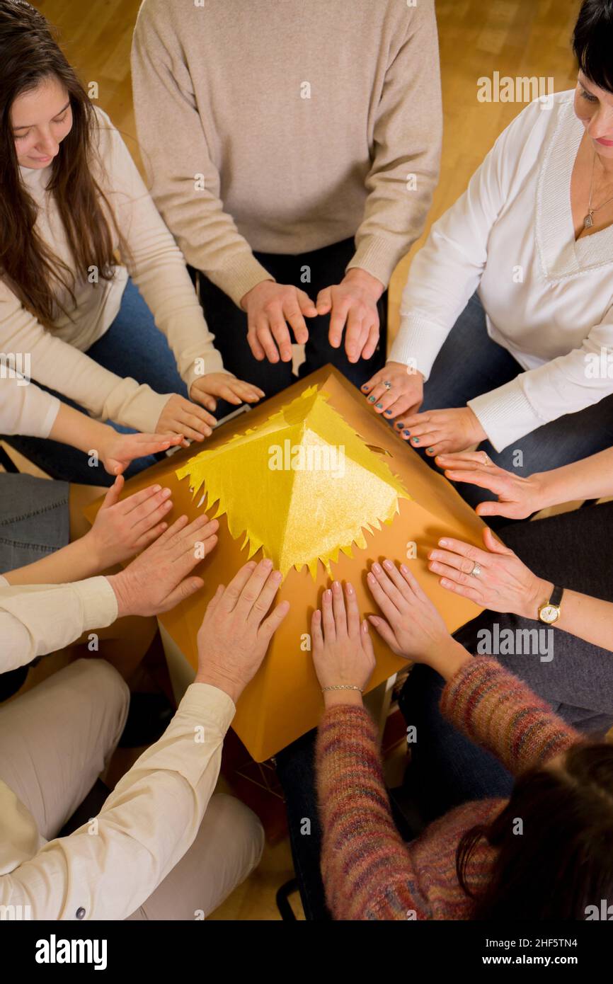Group meditation aims to heal the whole world from coronavirus. Group charge of the energy of the pyramid of desires in the stream of reiki Stock Photo