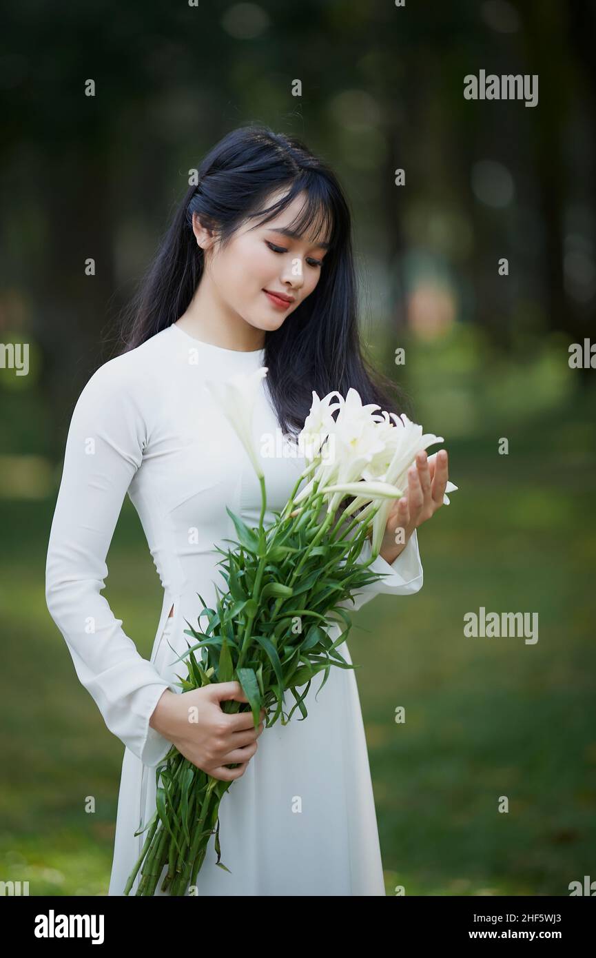 Ho Chi Minh City, Vietnam: Portrait women in white ao dai Vietnam, The Ao dai ( long-dress Vietnamese) is traditional costume of Vietnamese woman Stock Photo