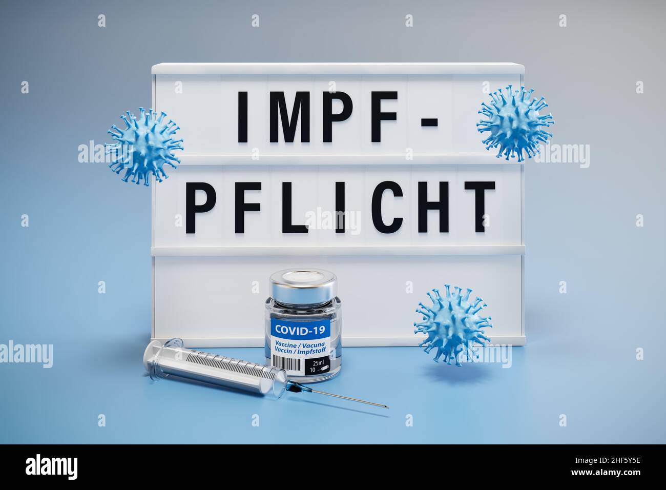 The German word 'Impfpflicht' (vaccine mandate) displayed on a lightbox. Syringe, virus models and a bottle of vaccine around. Stock Photo