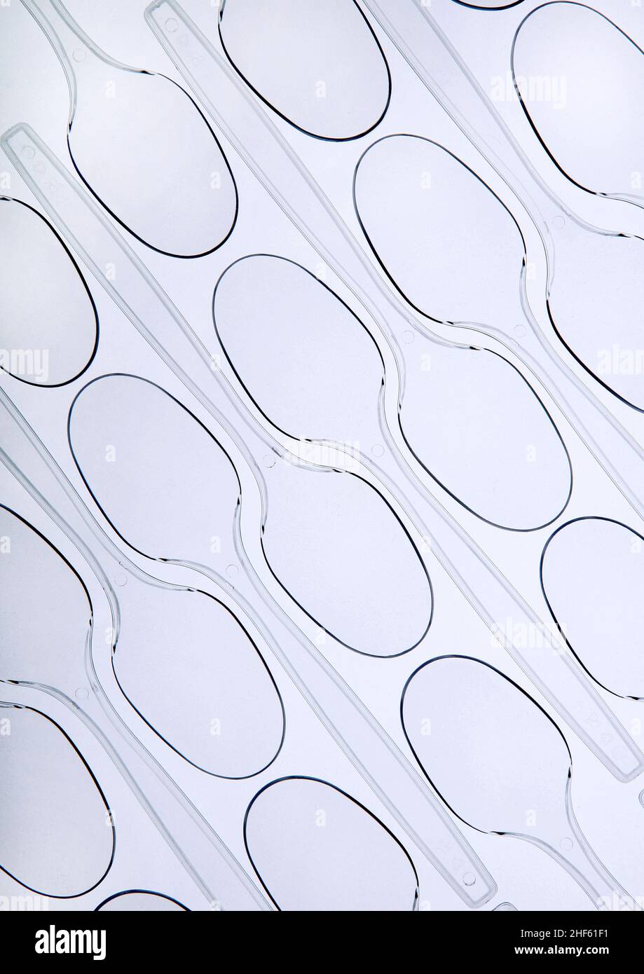 Tessellated pattern of plastic disposable spoons Stock Photo