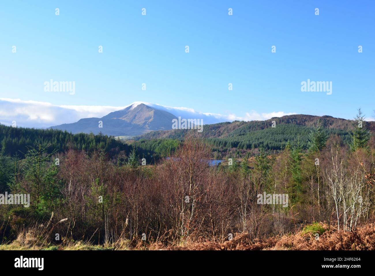 Mountains, Clouds, Forests, Blue skies and beautiful scenery on a trail walk in Gwydyr forest Snowdonia national park Wales on a January morning. Stock Photo