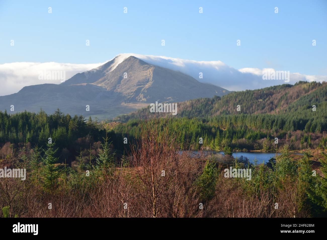 Mountains, Clouds, Forests, Blue skies and beautiful scenery on a trail walk in Gwydyr forest Snowdonia national park Wales on a January morning. Stock Photo