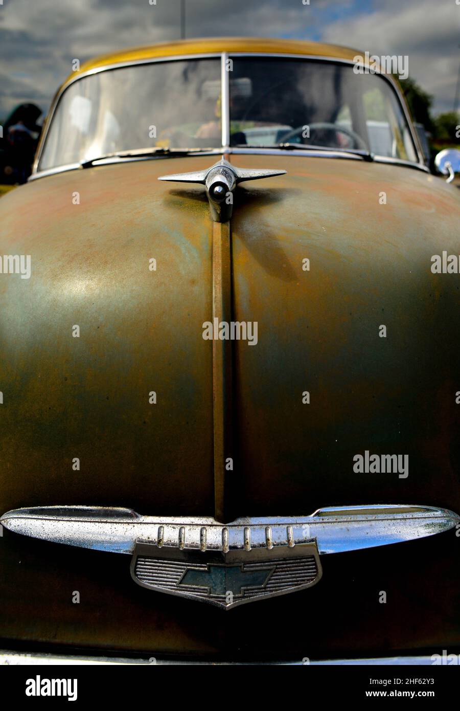 Old 19502 Chevrolet front end detail with chrome hood ornament and patina finish, club members car of Stockport Rainy City Cruisers. Stock Photo