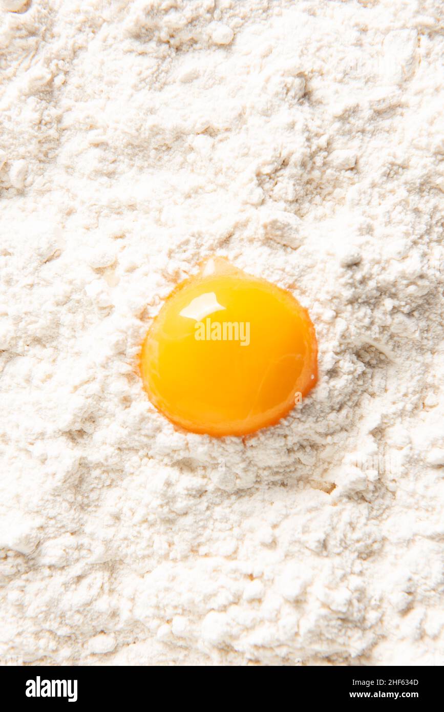 View from above of egg yolk on flour. Stock Photo