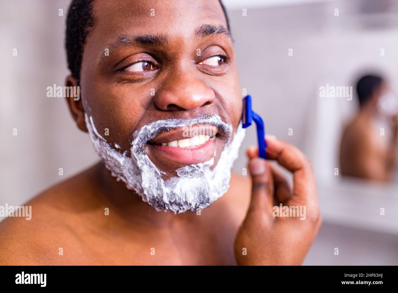 hispanic man put on foam on beard perfume lotion or skin care cream for