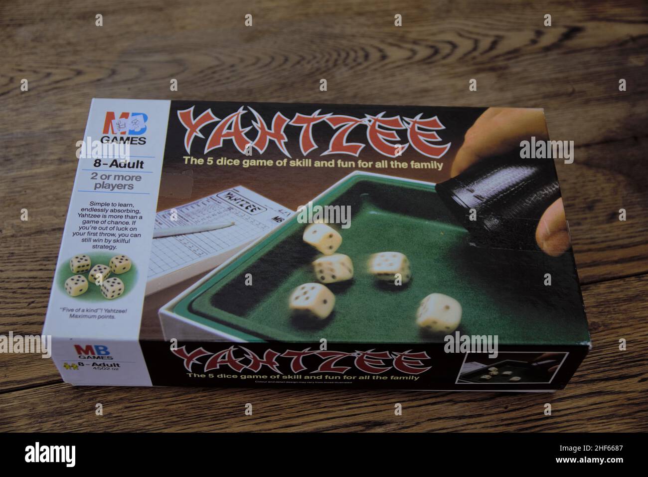 Yahtzee is a fun game for all the family. A dice game made by Milton Bradley (now owned by Hasbro), players roll the dice three times and log scores o Stock Photo