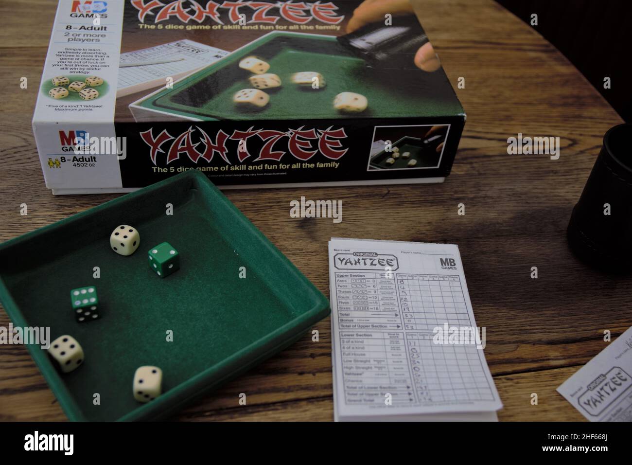 Yahtzee is a fun game for all the family. A dice game made by Milton Bradley (now owned by Hasbro), players roll the dice three times and log scores o Stock Photo