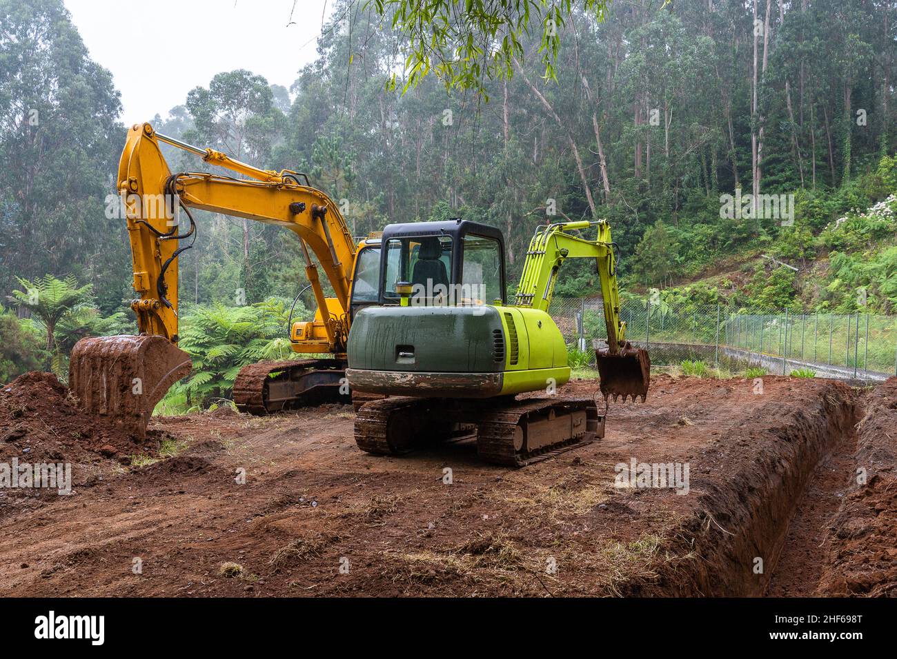 Two excavators working in Madeira island, Portugal. Stock Photo