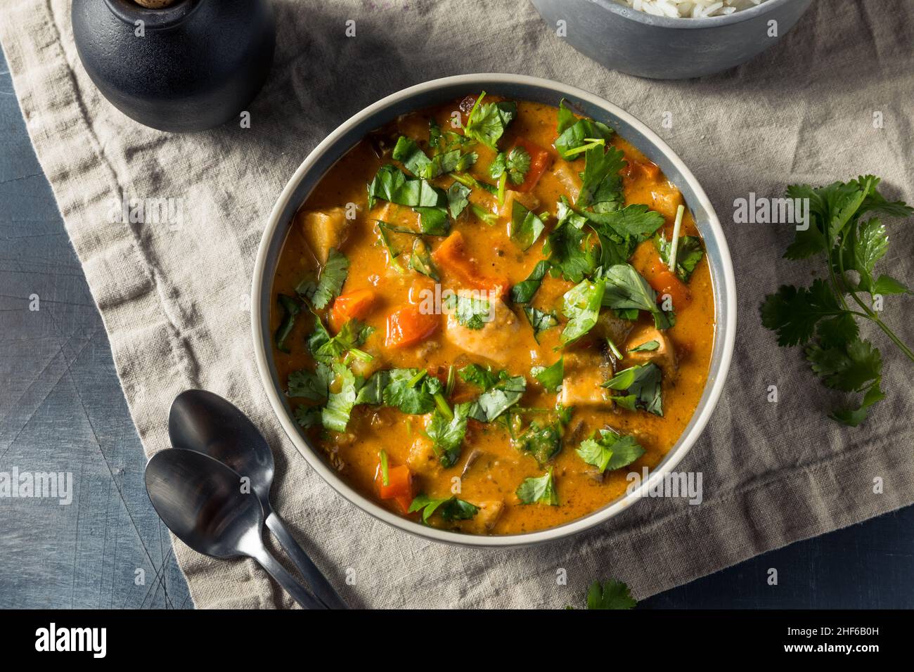 Homemade Red Chicken Curry with Cilantro and Rice Stock Photo