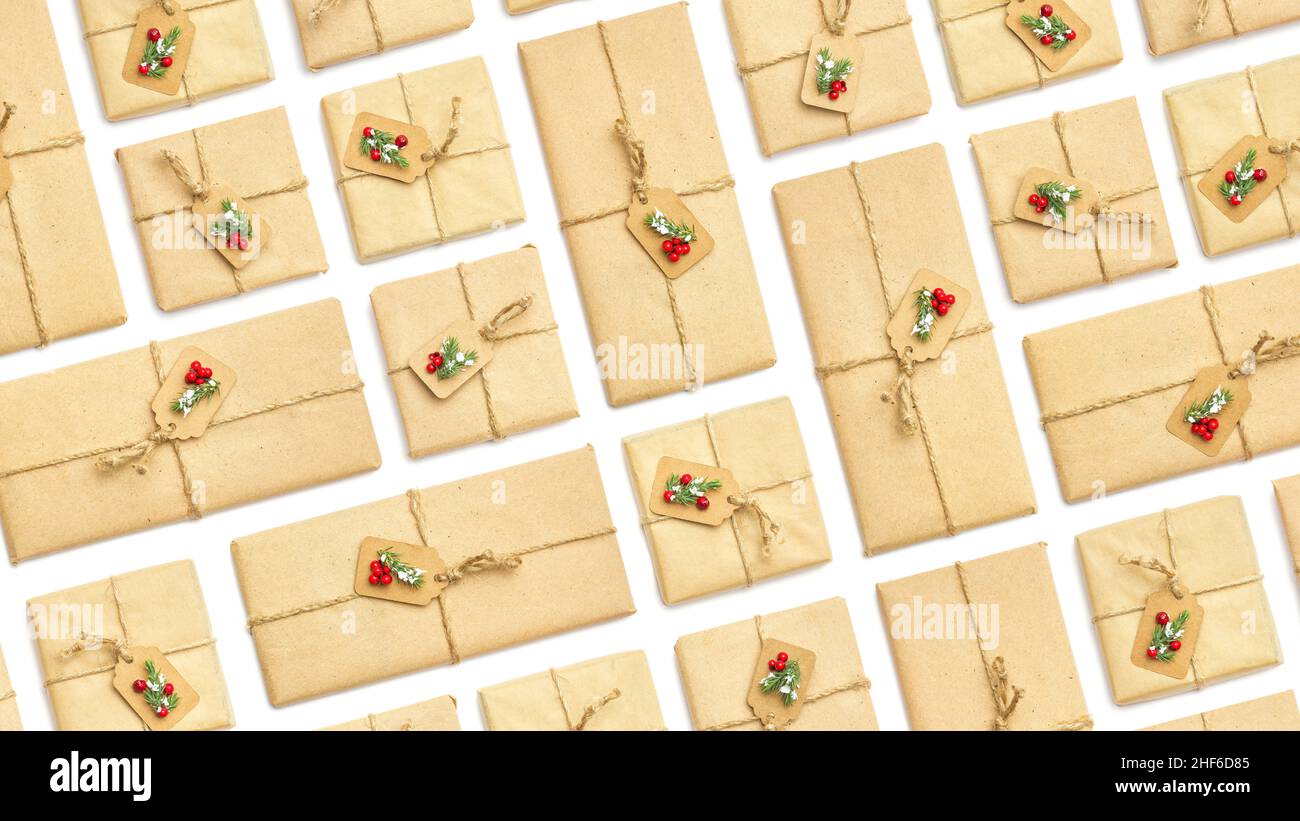 Background from holiday vintage gift packaging with red berries and spruce branches on white isolated background, top view Stock Photo