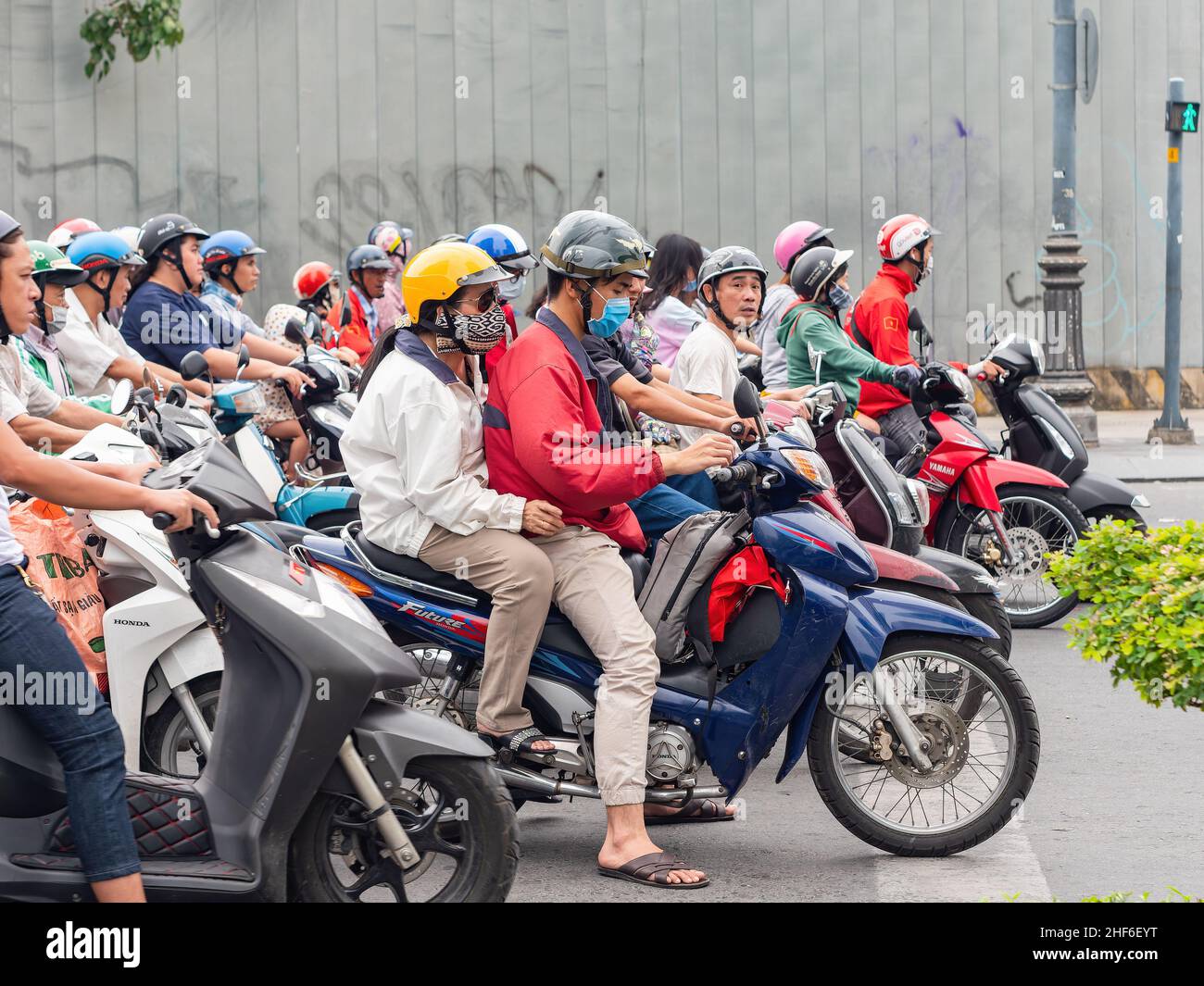 Motorbike drivers waiting at a traffic light in Ho Chi Minh City, Vietnam. Stock Photo