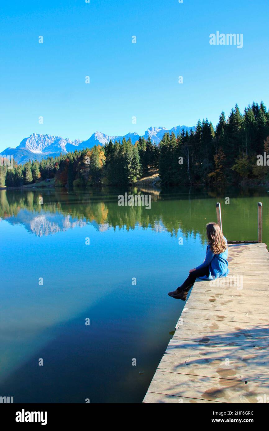 Woman on jetty at the beautiful Geroldsee,  Germany,  Bavaria,  Upper Bavaria,  Werdenfelser Land,  near Mittenwald,  blue,  blue sky,  cloudless Stock Photo