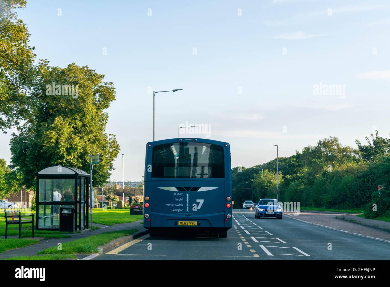 23rd August 2019 - Durham, UK: British bus travelling to Middlesbrough via Stockton pulls over at a bus stop, cars behind have to wait due to on comin Stock Photo