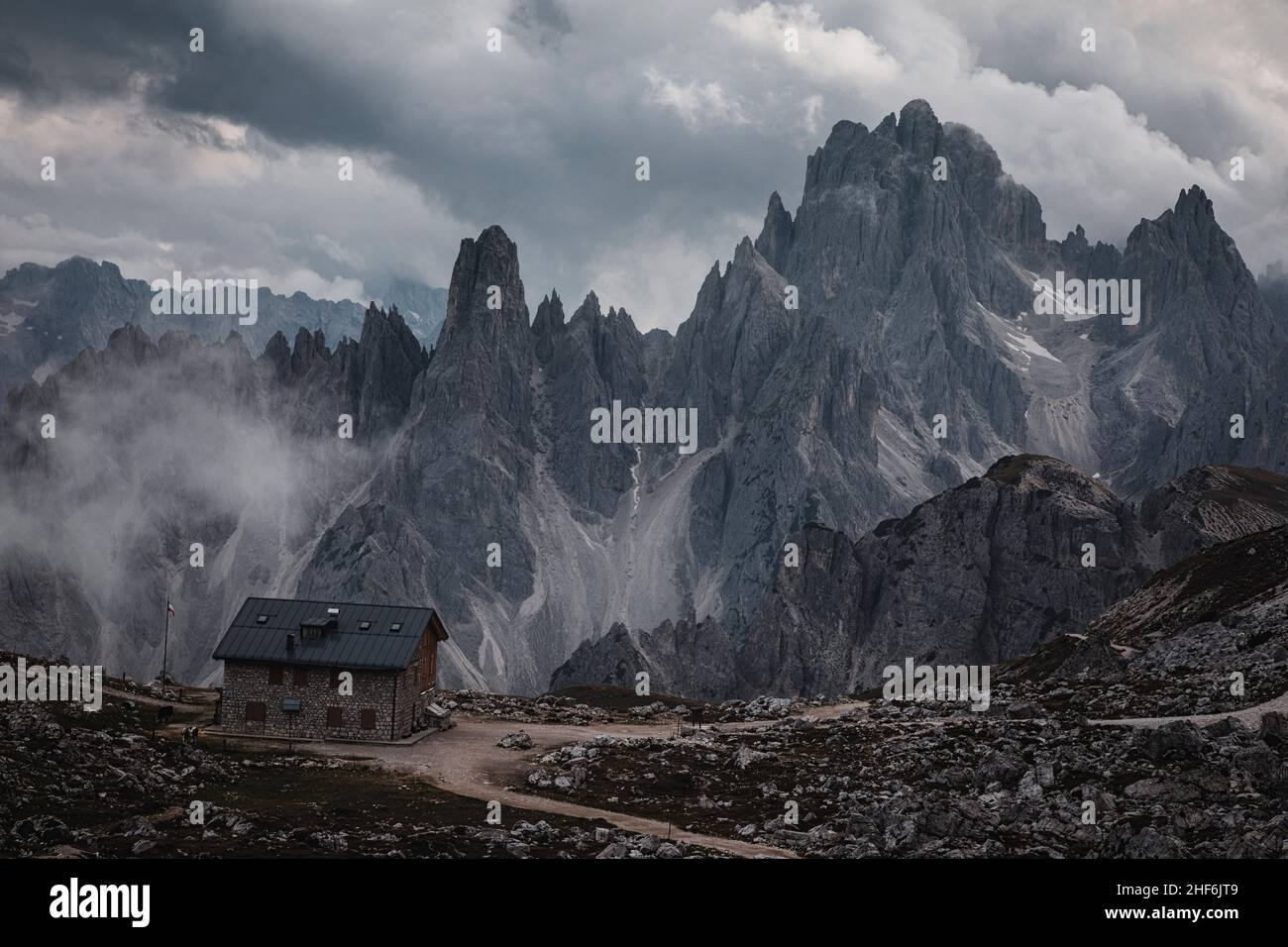 Mountain hut near the Three Peaks and in the background the Cadini di Misurina. Stock Photo