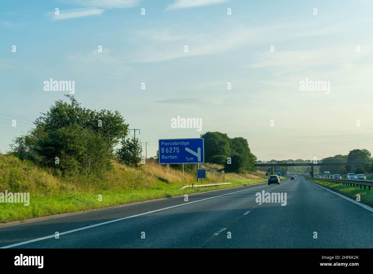 Darlington, UK - 23rd August 2019: Blue British Motorway sign with space for copy text on the A1 motorway directing traffic drivers towards Piercebrid Stock Photo