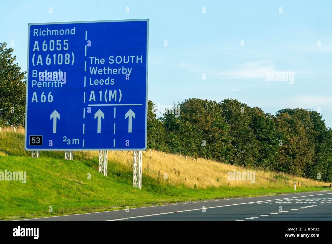 Leeds, UK - 23rd August 2019: Cars drive down the A1 British motorway with blue highway signs directing drivers to Richmond, Leeds, Brough, Wetherby, Stock Photo