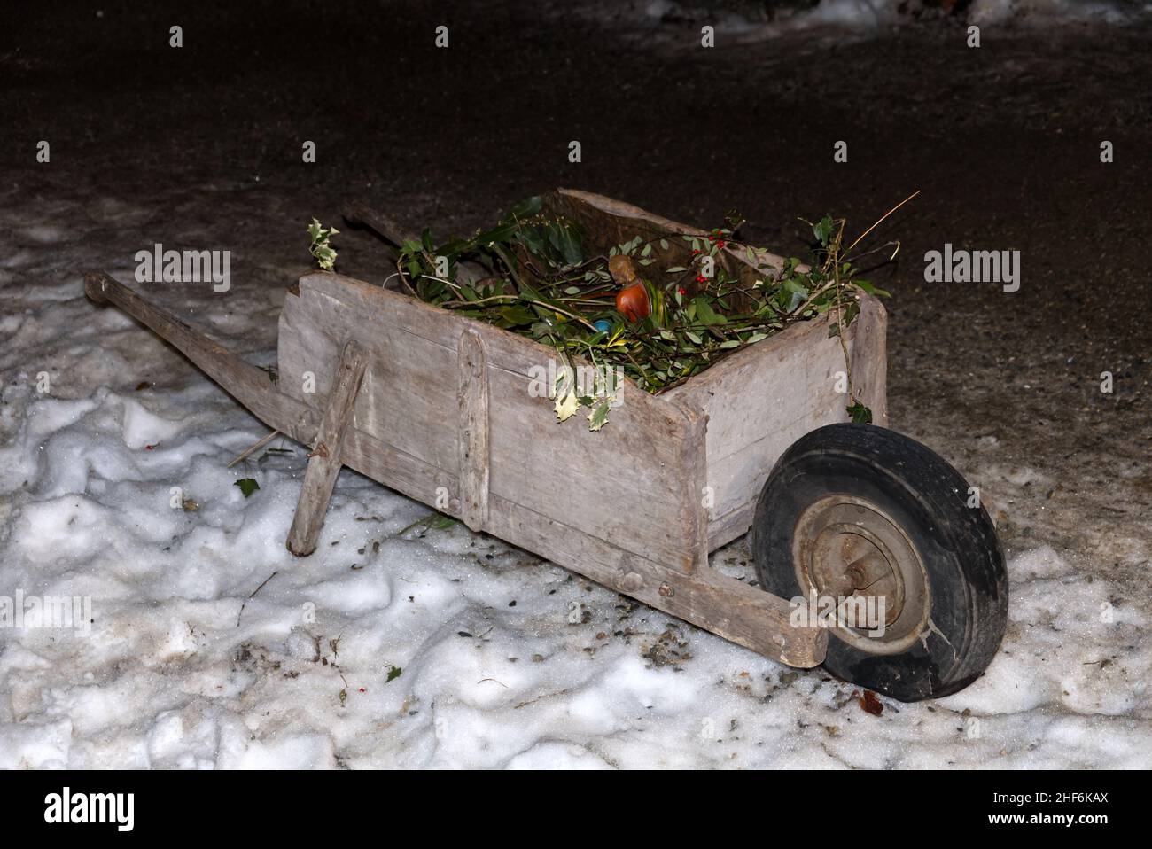 an old wooden wheelbarrow from the 30s in an alpine hut Stock Photo
