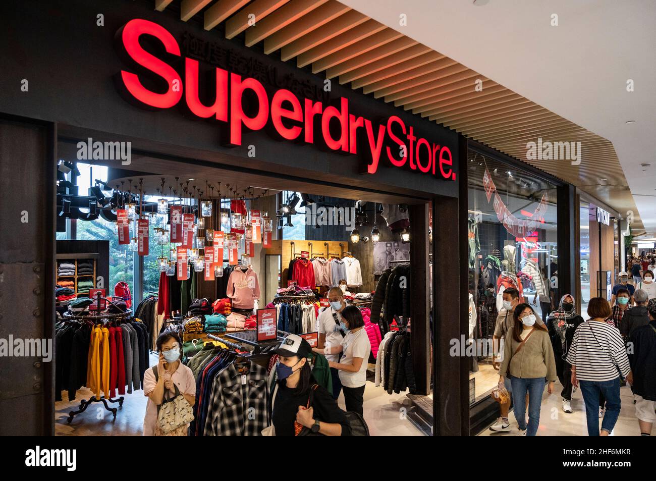 Hong Kong, China. 13th Jan, 2022. Shoppers walk past the British clothing  brand, Superdry store and