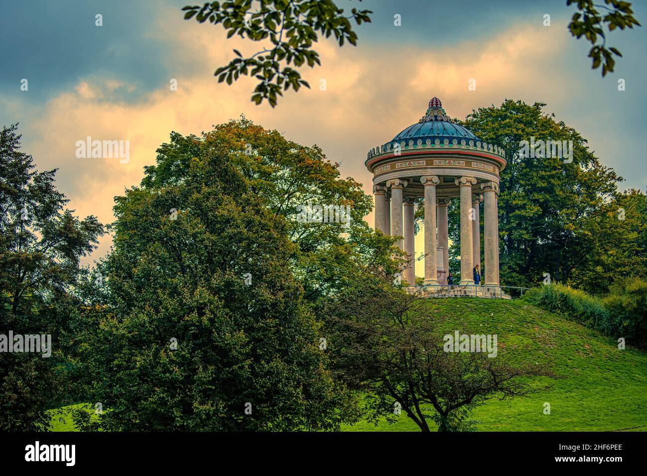 English Garden of Munich - The beautiful temple architecture of the Monopteros at the fall season with sunset clouds Stock Photo