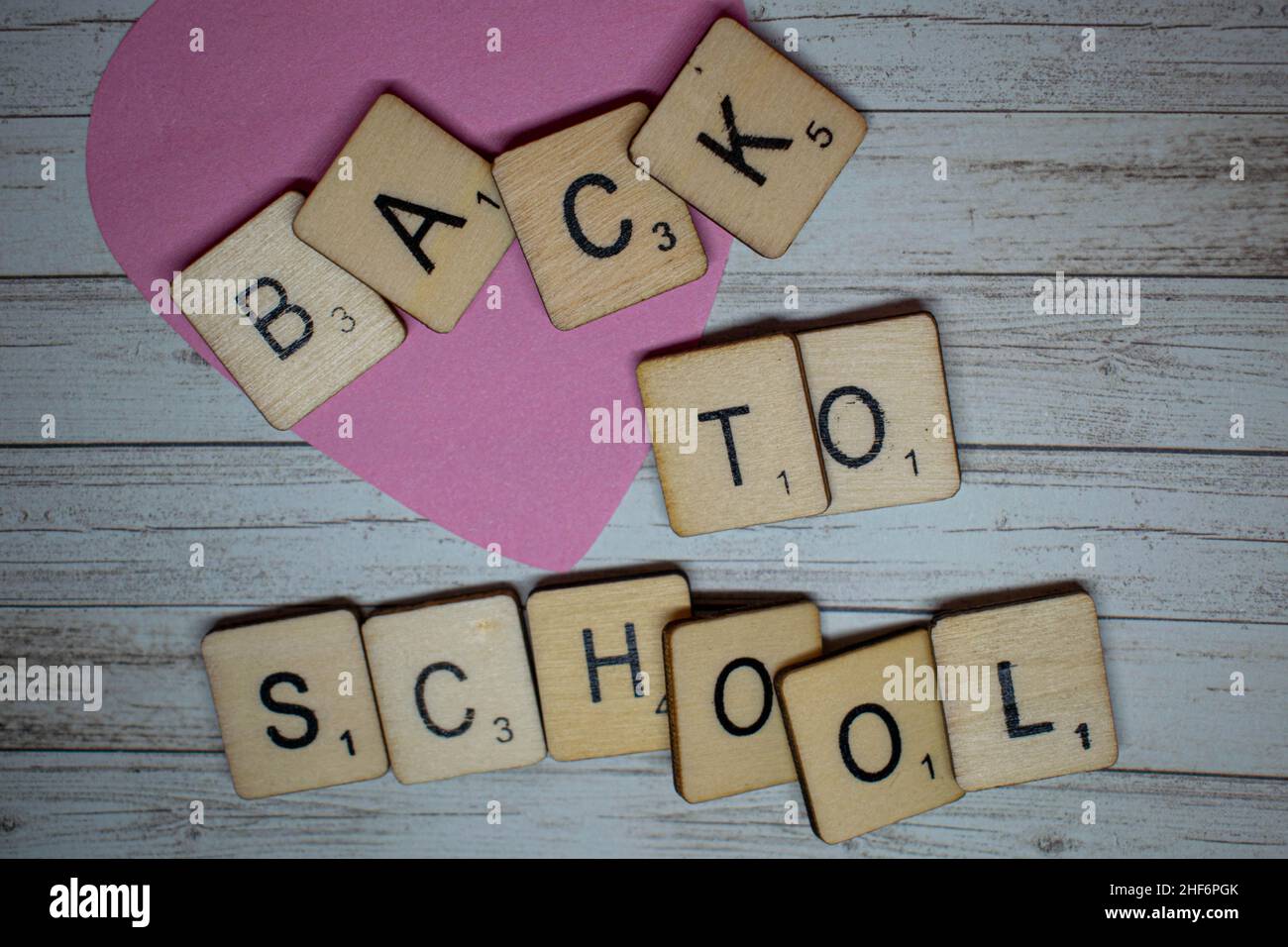 Back to School concept. Back to school spelled out on scrabble letters on a rustic wooden background. Preparation for going back to school after the s Stock Photo