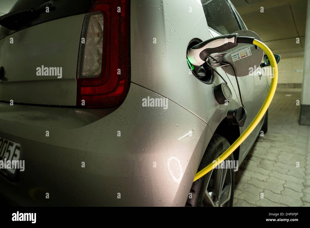 Charging your car at home. Te electric mobility open the door for the trend of charging your car at your own garage to increase your comfortable lifestyle. Stock Photo