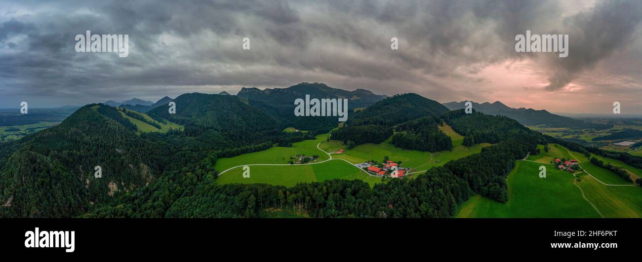 Wonderful aerial view over idyllic farmland in mountainrange to the bavarian alps at the recreation and hiking aera Chiemgau in southern germany Stock Photo