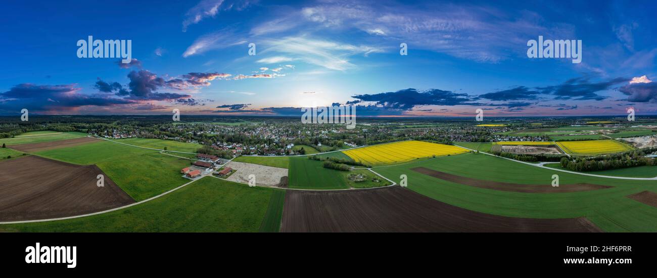 Agricultural view over growing fields and a idyllic placed village in the background,  captured by a drone with copy space in southern bavaria,  germany Stock Photo