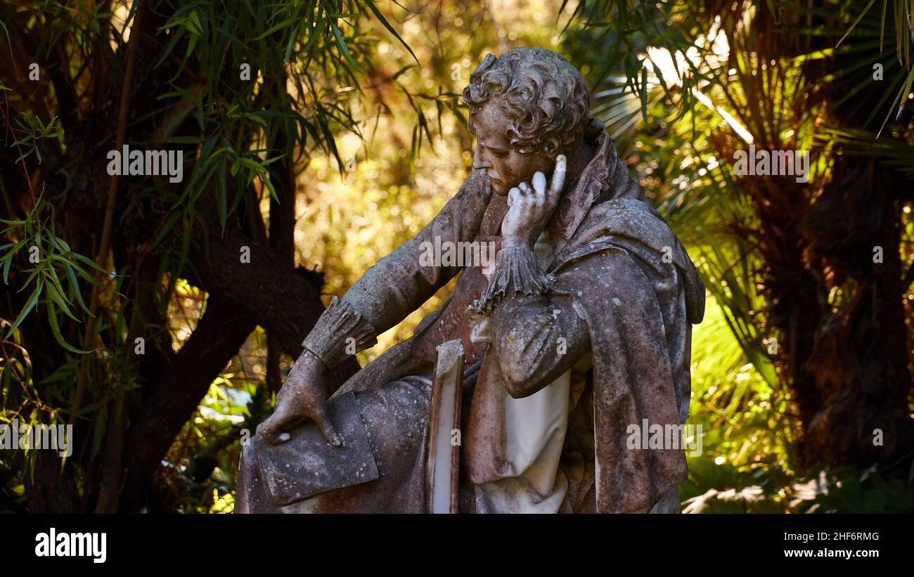 Greece,  Greek Islands,  Ionian Islands,  Corfu,  Achilleion,  residence of Empress Sissis,  built in 1889,  architecture based on Greek mythology,  garden,  marble statue,  man with head supported on hand,  surrounded by greenery Stock Photo