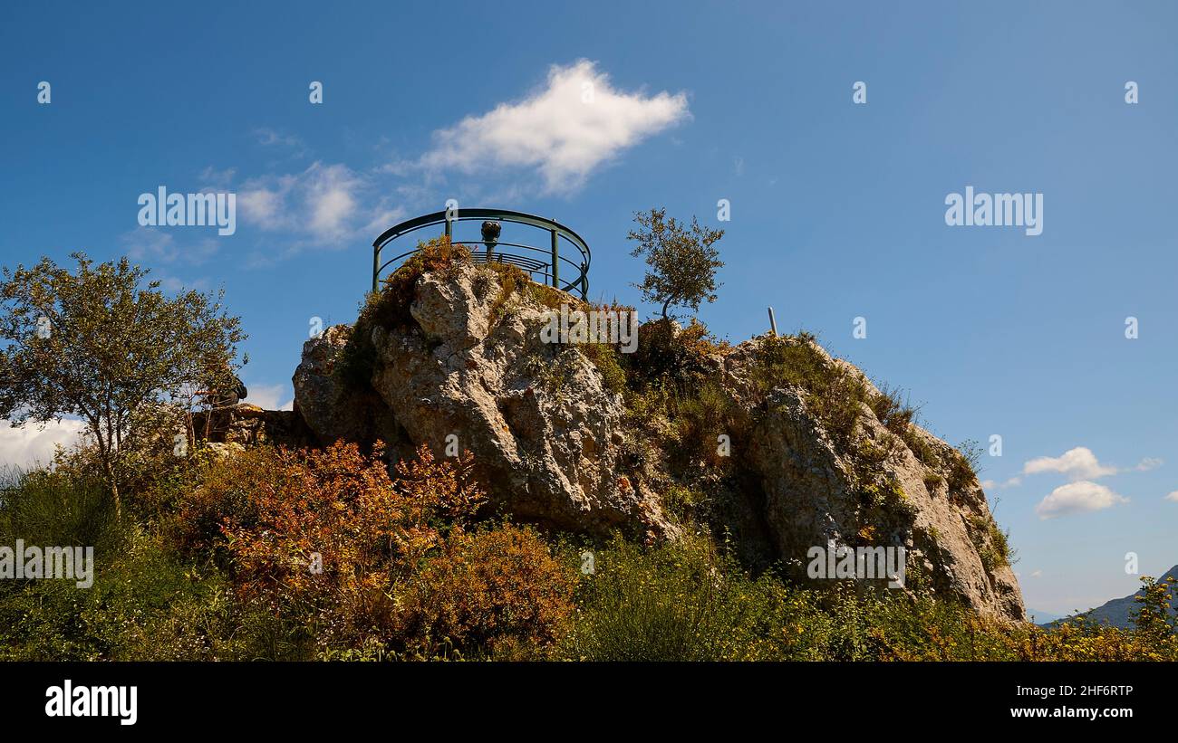 Greece,  Greek Islands,  Ionian Islands,  Corfu,  central north of the island,  viewpoint 'Emperor's Throne',  view of the west and east coast,  view platform,  blue sky,  white clouds,  mountains on the mainland,  view up to the empty,  round ,  iron viewing platform,  which is mounted on a prominent rock,  blue sky with isolated white clouds Stock Photo
